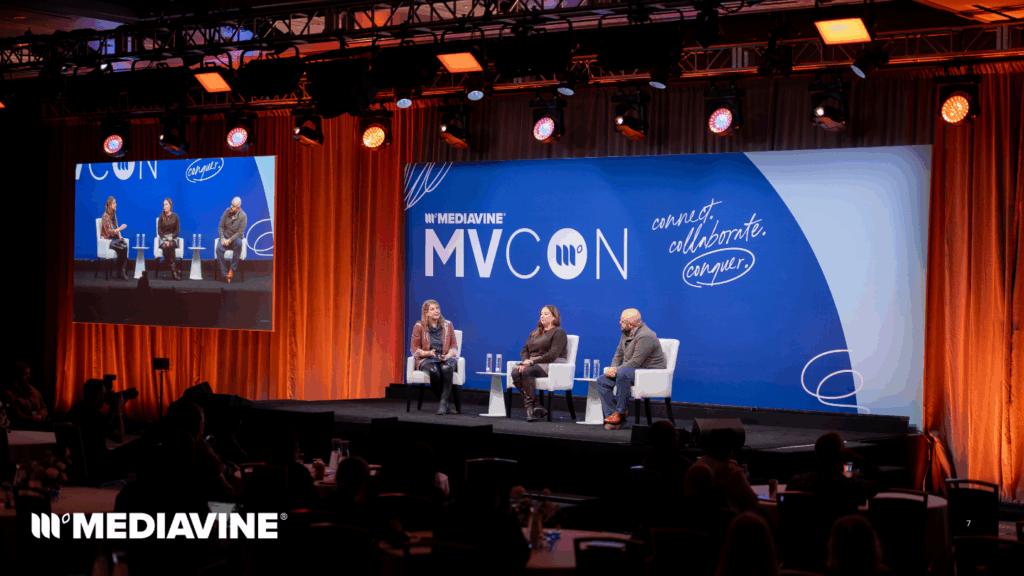Photograph of Jenny Guy, Dorothy Kern, and Don Miner on stage at MVCon 2025