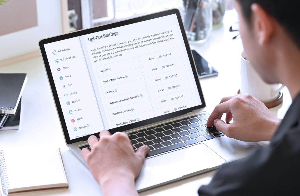 Person using a laptop to access "Opt-Out Settings" with options and more displayed on the screen.